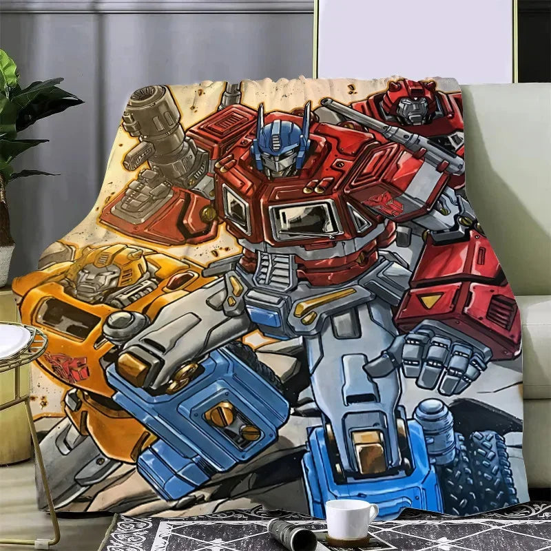 Plaid Transformers avec Optimus Prime en posture de combat, couleurs rouges, jaunes et fond décoratif – Transformers.