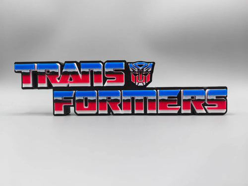 Transformers Plakette mit rotem und blauem Autobot-Logo – Dreidimensionale Schreibtischdekoration