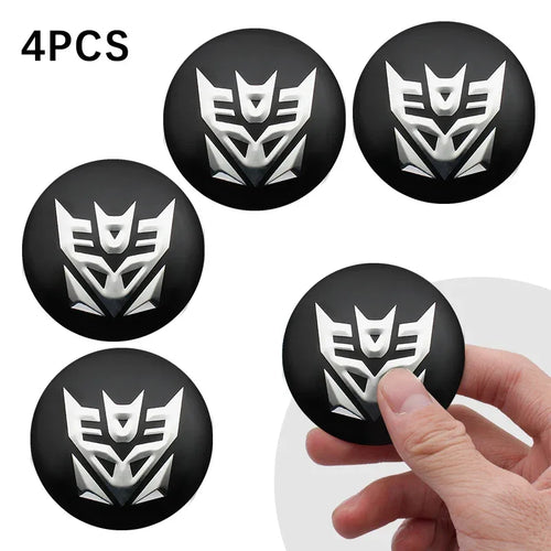 Lot de 4 emblèmes noirs Decepticon argentés tenus en main, forme ronde – Transformers.