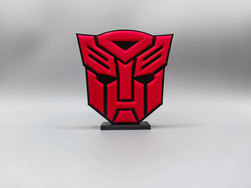 Transformers-Plakette mit intensiv rotem Autobot-Logo – massive Schild-Dekoration für den Schreibtisch