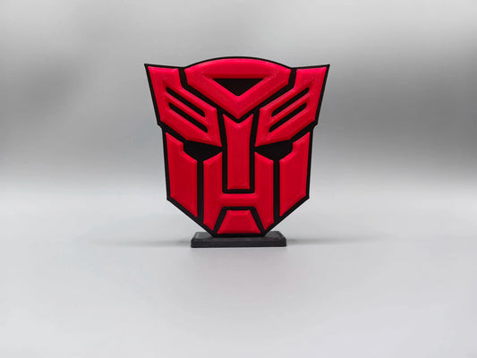 Transformers-Plakette mit intensiv rotem Autobot-Logo – massive Schild-Dekoration für den Schreibtisch