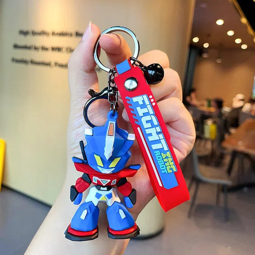 Porte-clés robot bleu style chibi avec tag rouge, figurine articulée en main – Transformers.